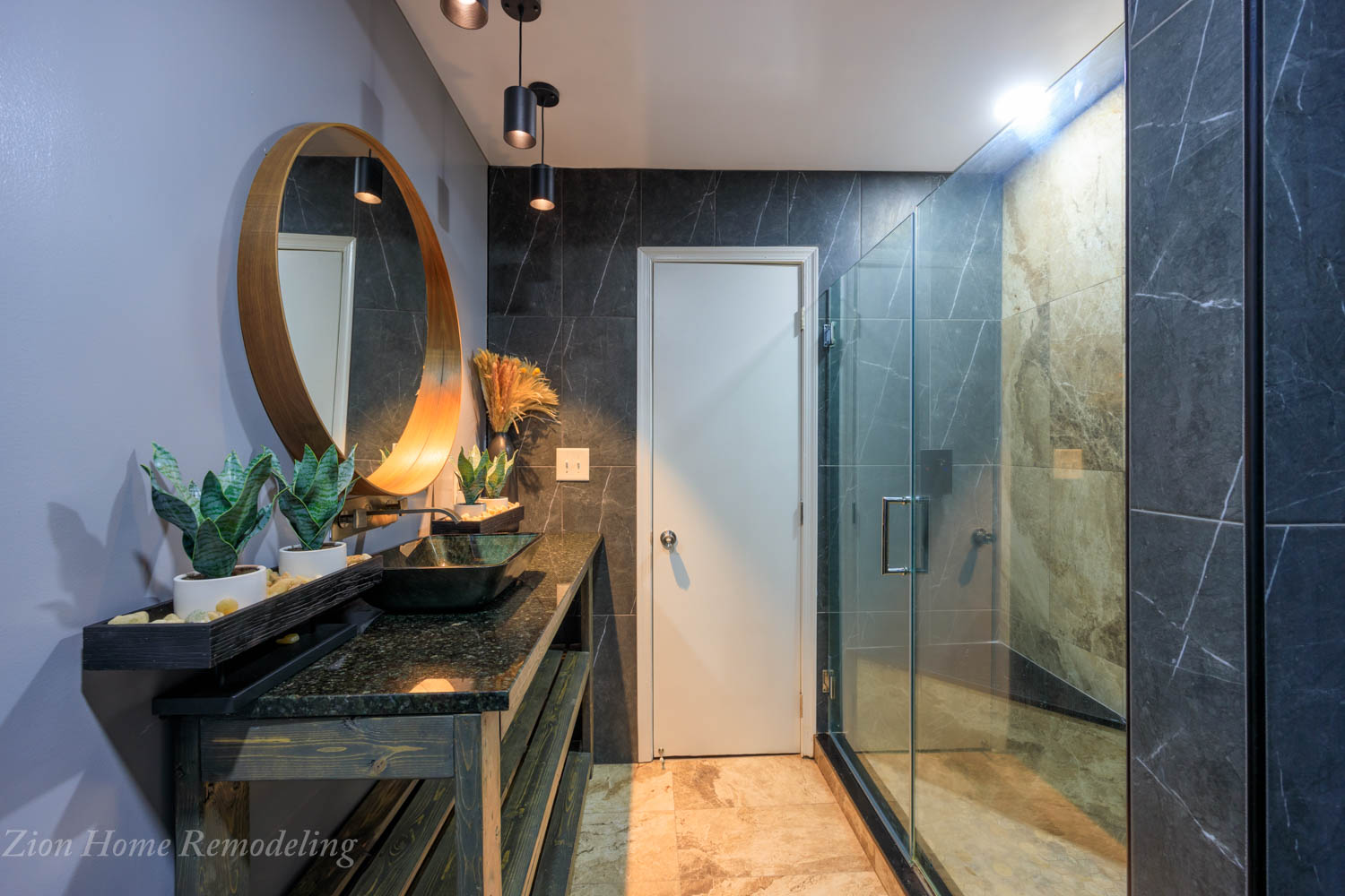 Spa-inspired bathroom in Bowie, MD, US, featuring black marble walls, accent wall with textured tiles, angle corner bench in the shower, round mirror, pendant light, custom vanity with granite top, and wall-mounted faucet.