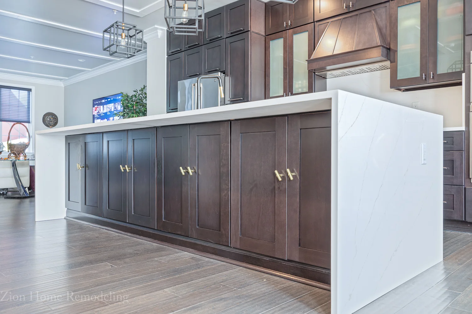 Kitchen renovation in Upper Marlboro, MD, US with Calacatta Unique Gold waterfall quartz island and back cabinets with golden hardware.