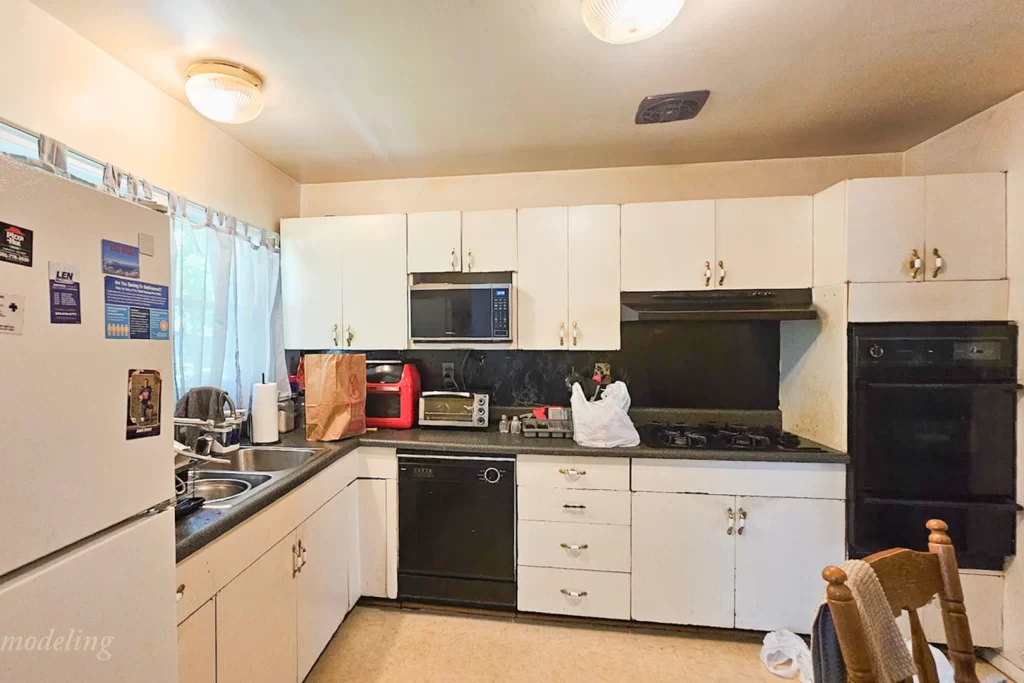 Before picture showing old frameless cabinets, laminate countertops, outdated appliances, a double sink, and vinyl tile flooring — kitchen remodel before photo in Clinton, MD, US.