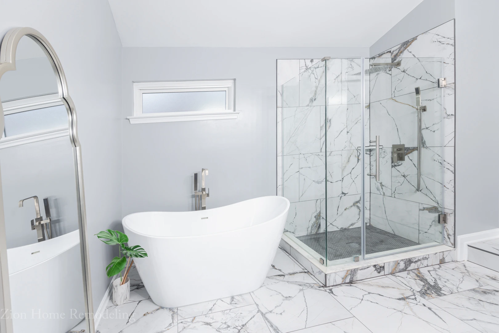 After-picture of a bathroom restoration & remodel in Clinton, MD, US, featuring custom walk-in shower with glass penny mosaic floor, frameless corner enclosure, freestanding tub, and porcelain tile flooring by Zion Home Remodeling, a bathroom remodeler serving Prince George's County.