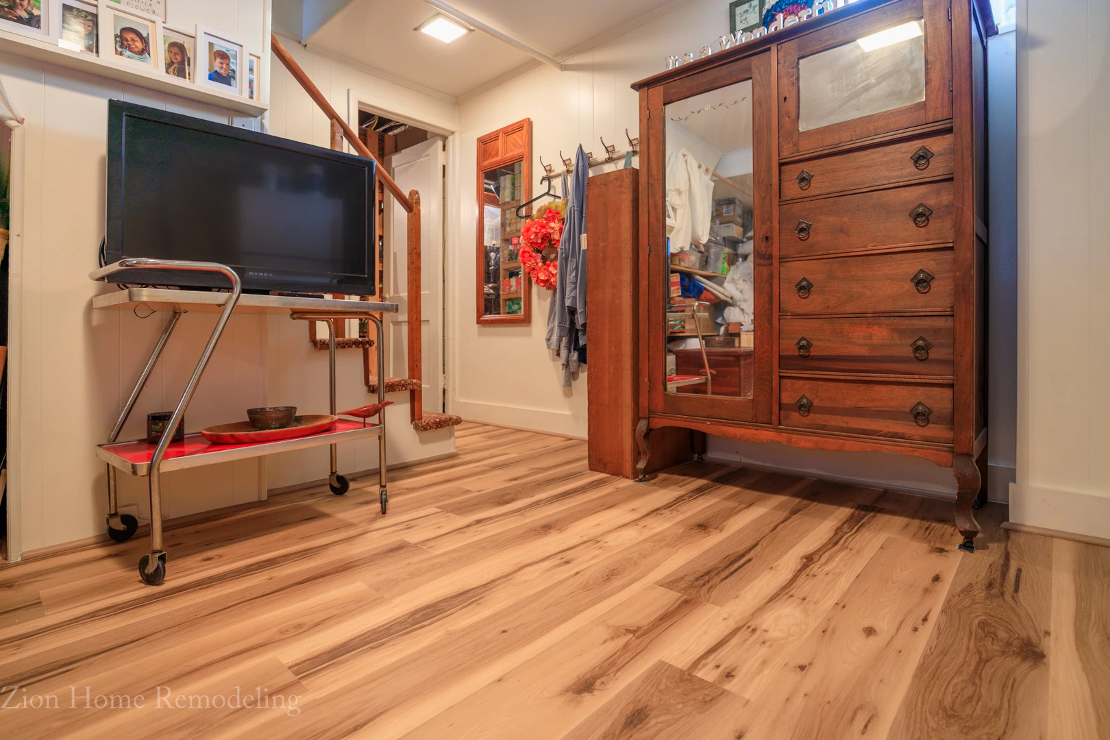 Finished basement remodeling project in Cheverly, MD, US, featuring Jamestown Hickory waterproof luxury vinyl plank flooring with quarter round trim, installed by Zion Home Remodeling®, a basement finishing & remodeling contractor serving Prince George’s County, MD, and the surrounding areas.